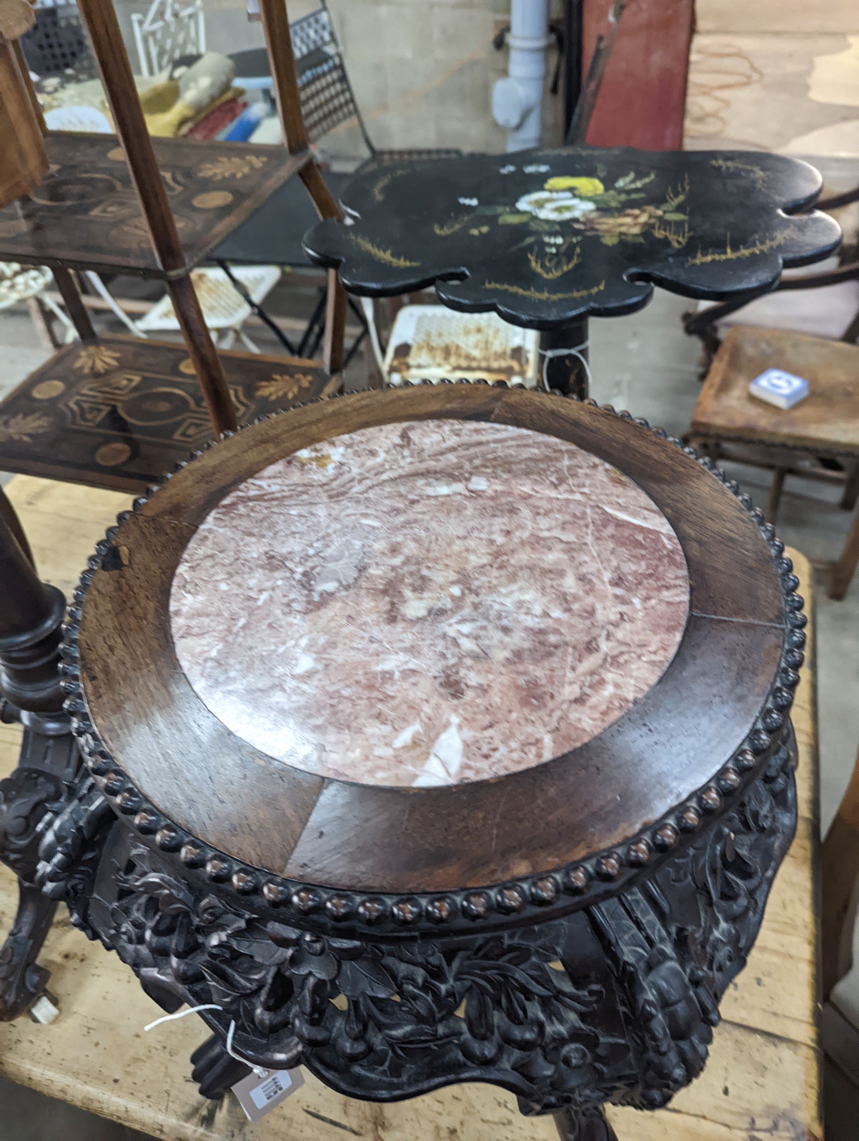 A 19th century Chinese carved hardwood jardiniere stand, with a rouge marble inset top, diameter 46cm, height 50cm